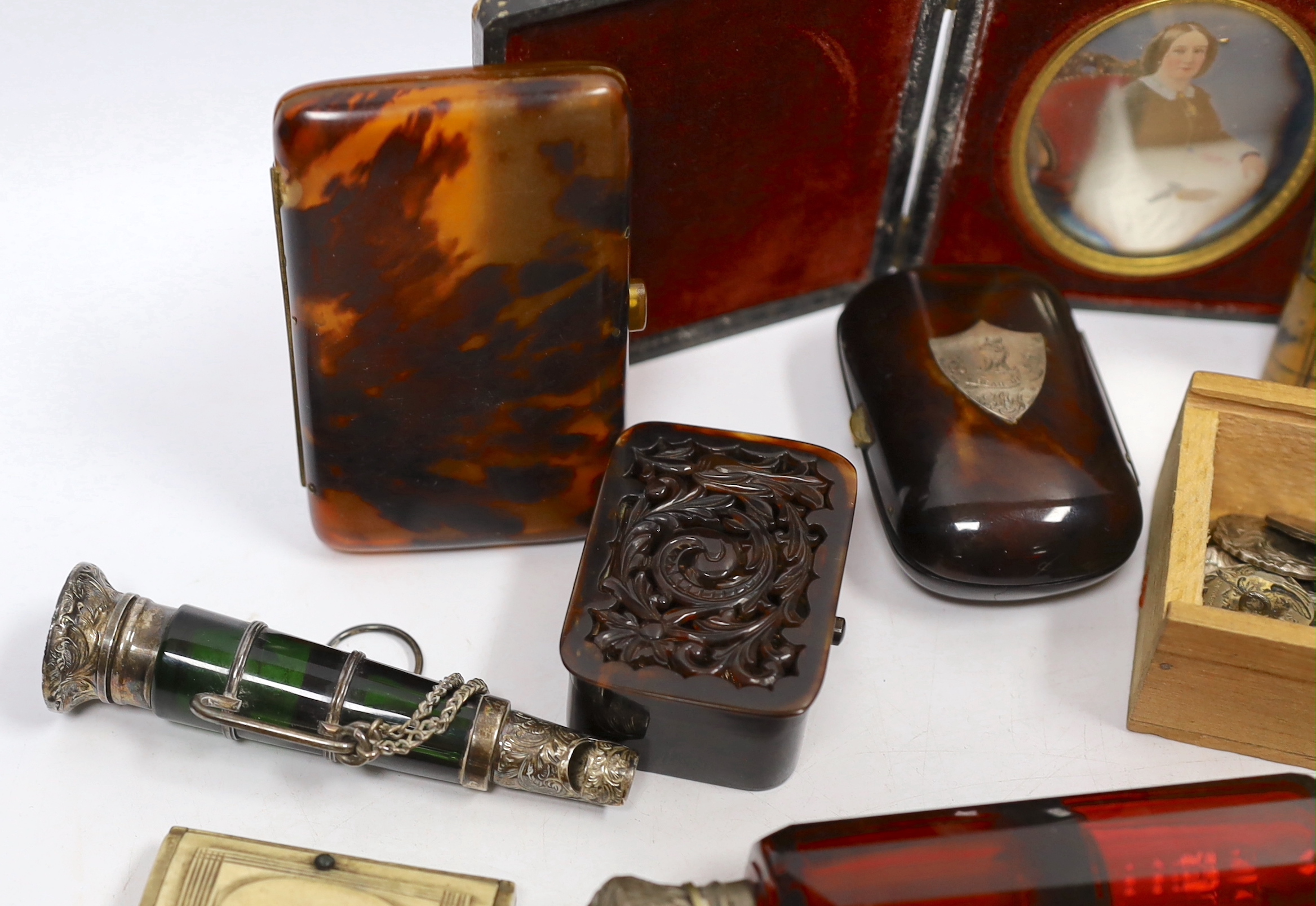 A group of vertu to include an unusual Victorian white metal mounted green glass combination scent bottle and whistle, a group of Art Nouveau silver buttons, carved tortoiseshell boxes, a double ended scent bottle etc.